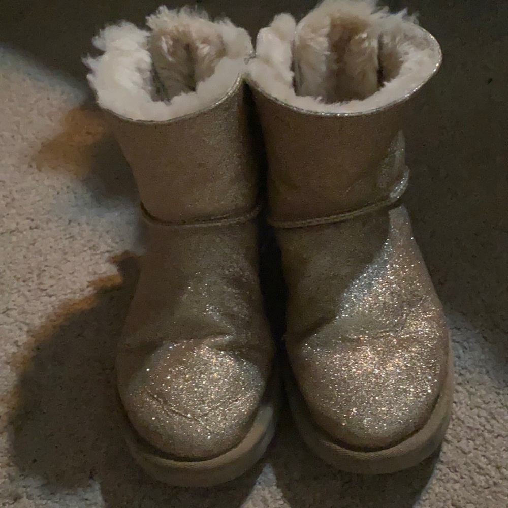 Glitter gold Ugg’s with bows on back.